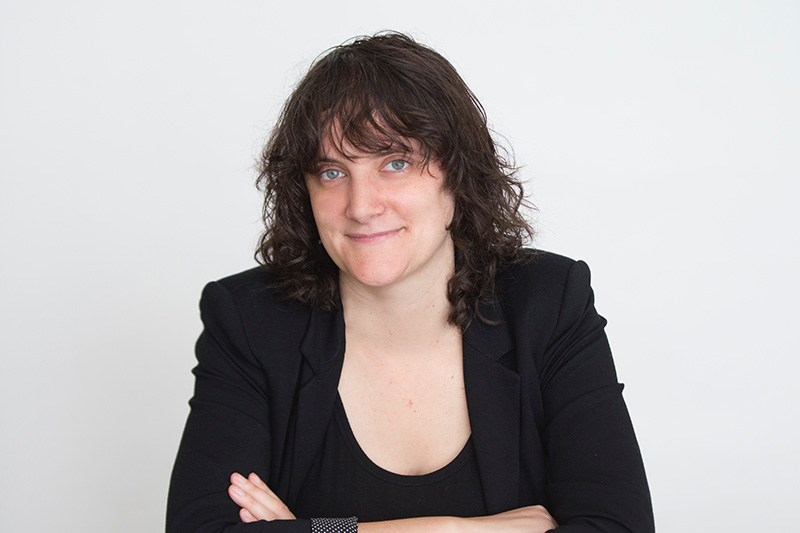 woman with dark hair wearing black top black jacket