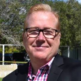 headshot of Brian Greig wearing glasses