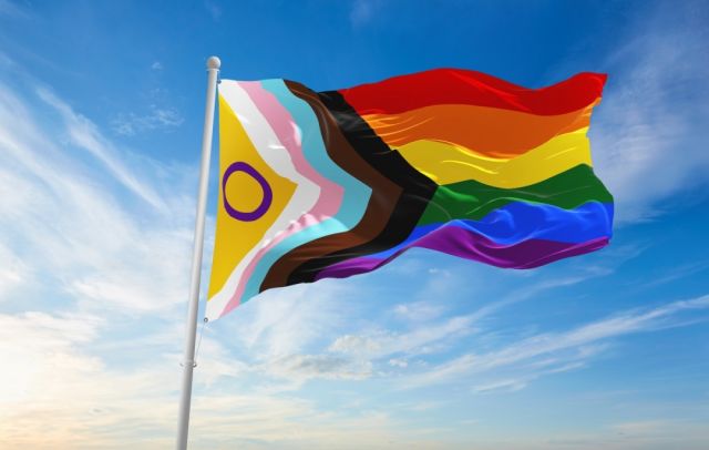 full rainbow flag and background of blue sky and white cloud