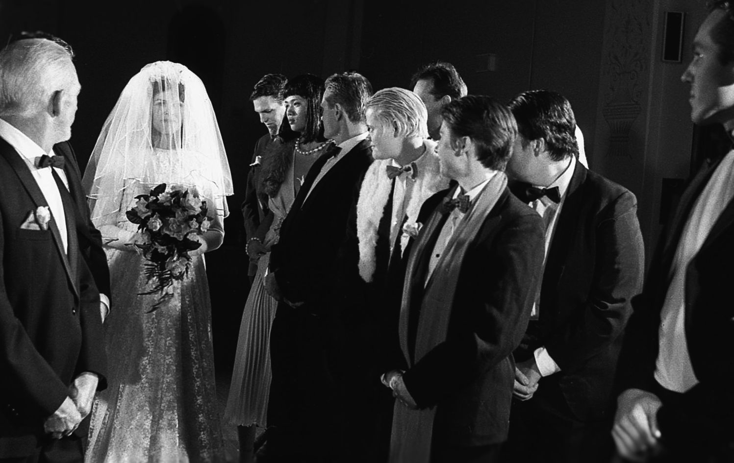 9 people in formal wear at camp wedding re-enactment