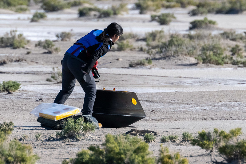 Lockheed Martin System Safety Engineer Victoria Thiem checks the sample return capsule from NASA’s OSIRIS-REx mission, shortly after iits return from the asteroid Bennu (Photo credit NASA/Keegan Barber)