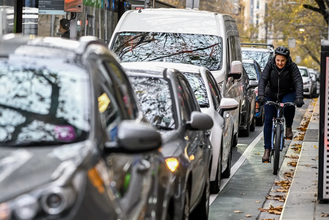 The Age: Cyclists make their way along a narrow bike lane along Collins Street. Credit: Joe Armao