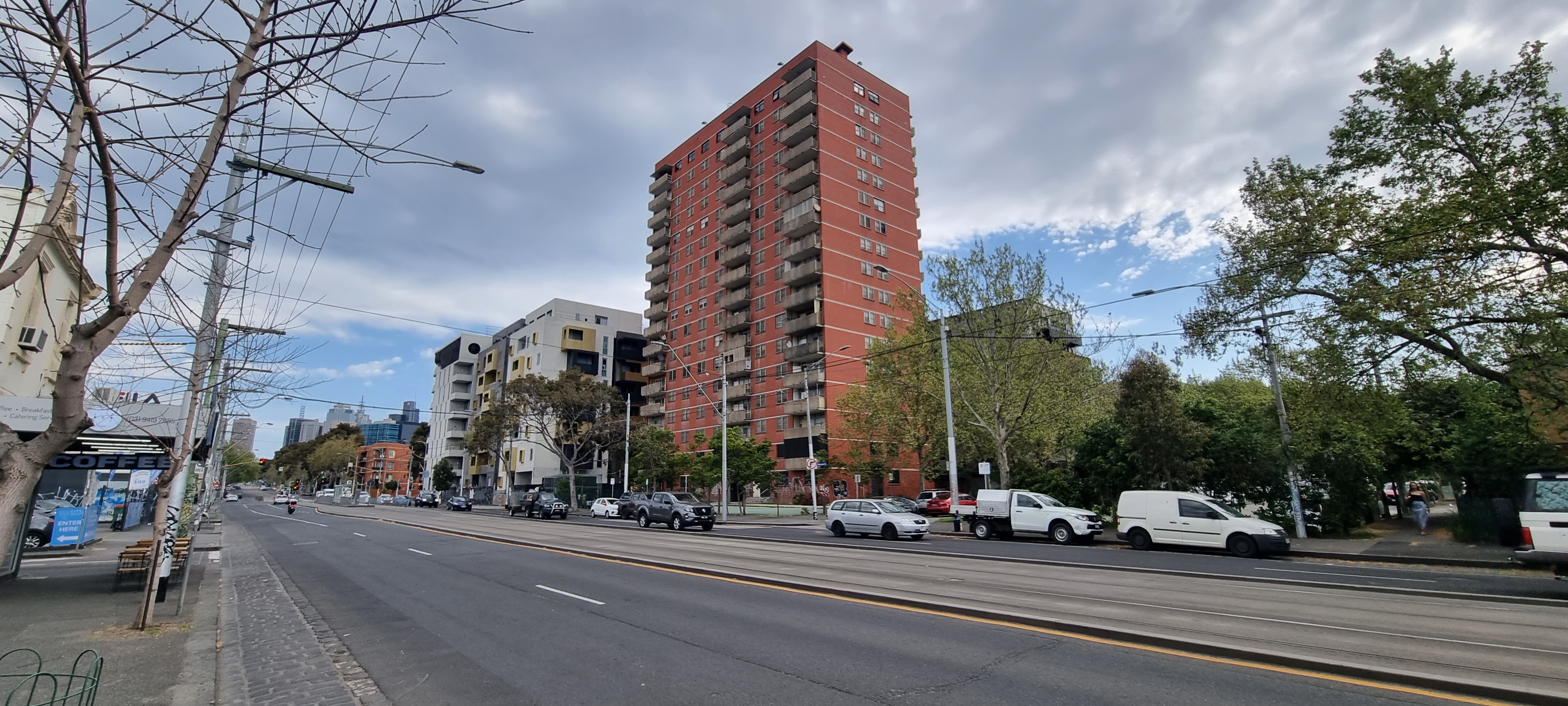 A photograph of the empty red-brick public housing tower in Carlton on Nicholson Street, taken from across the road.