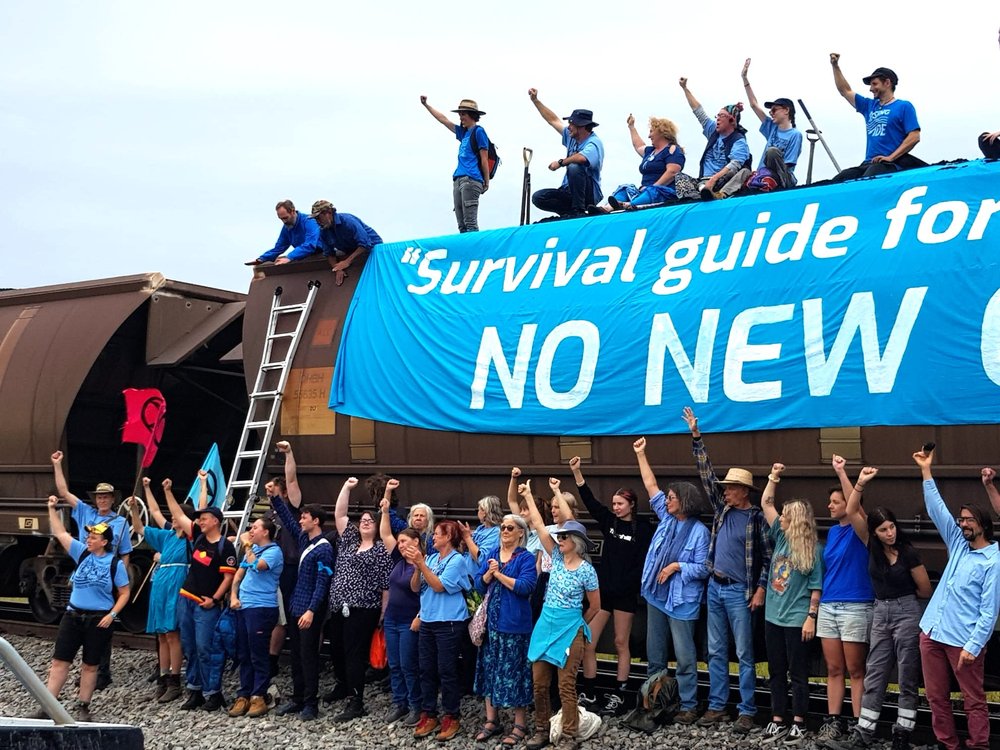 A photograph of Rising Tide activists occupying a freight train.