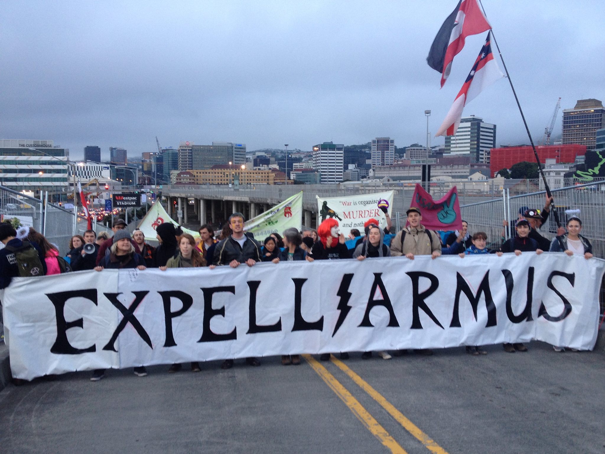 A number of protesters holding a sign that says "Expelliarmus!"