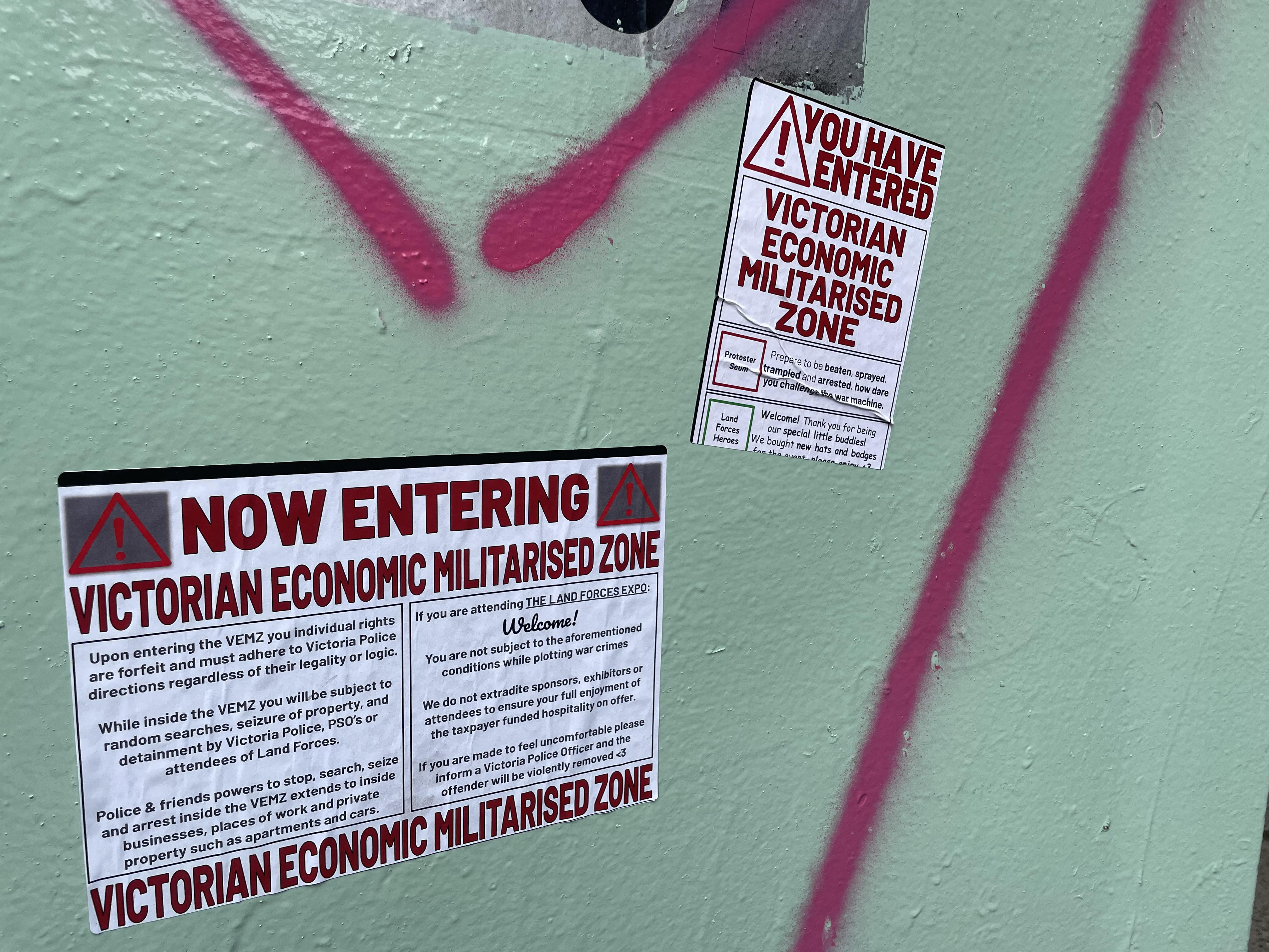 Stickers pasted up around the designated Police Special Powers Zone in Docklands this week at the site of the 2024 Land Forces Expo.