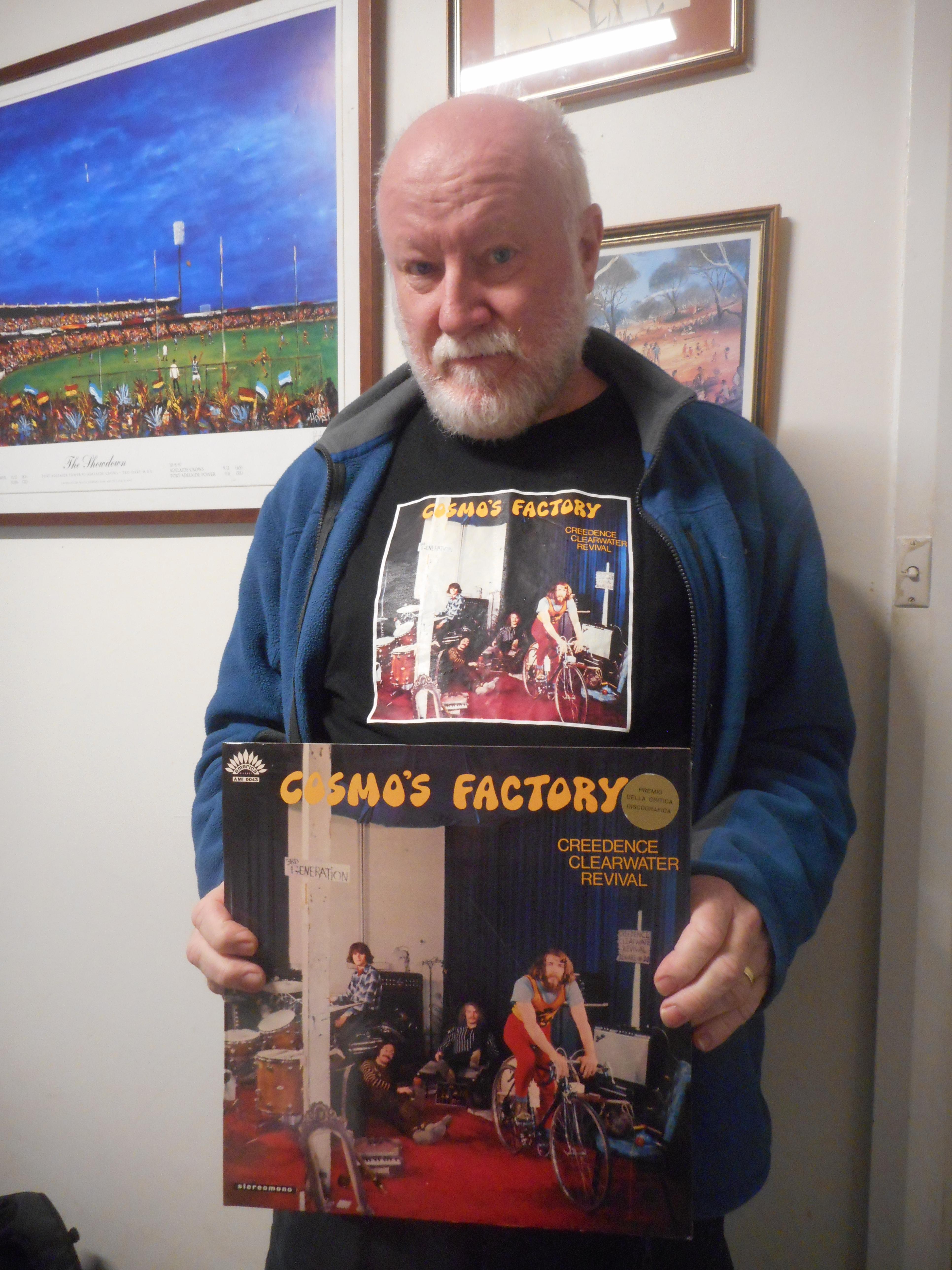 John A Tait displaying Cosmos Factory - shirt and LP