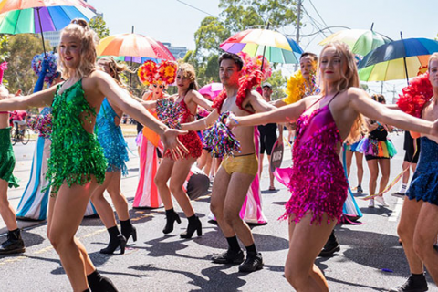 picture of people dancing hand in hand at Pride