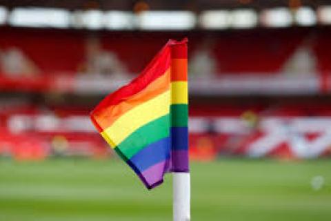 rainbow flag in front of grandstand at sports stadium