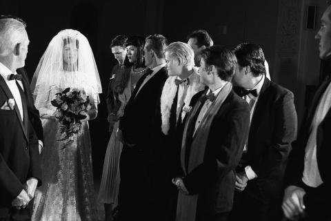 9 people in formal wear at camp wedding re-enactment