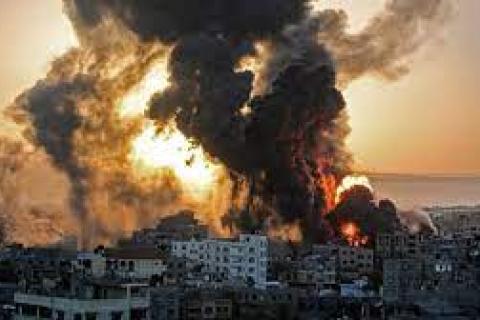 An aerial shot of the Gaza Strip in flames and smoke