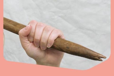 These Arms Hold. Hand holding women's weaponry against white background and pink border. 