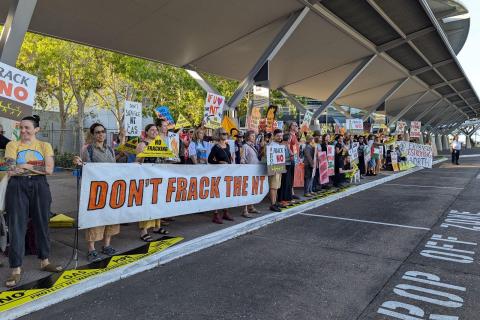 More than 100 community members protesting out front of NT Resources Week at Darwin Convention Centre.