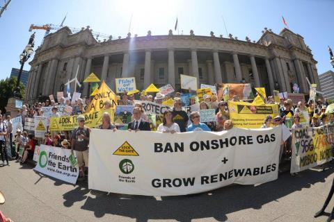 A group of community campaigners holding a banner in front of parliament