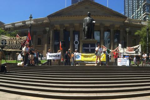 Activists with banners gather for speeches on the steps of the State Library of Victoria as part of a global day of action calling for 'No War with Iran'