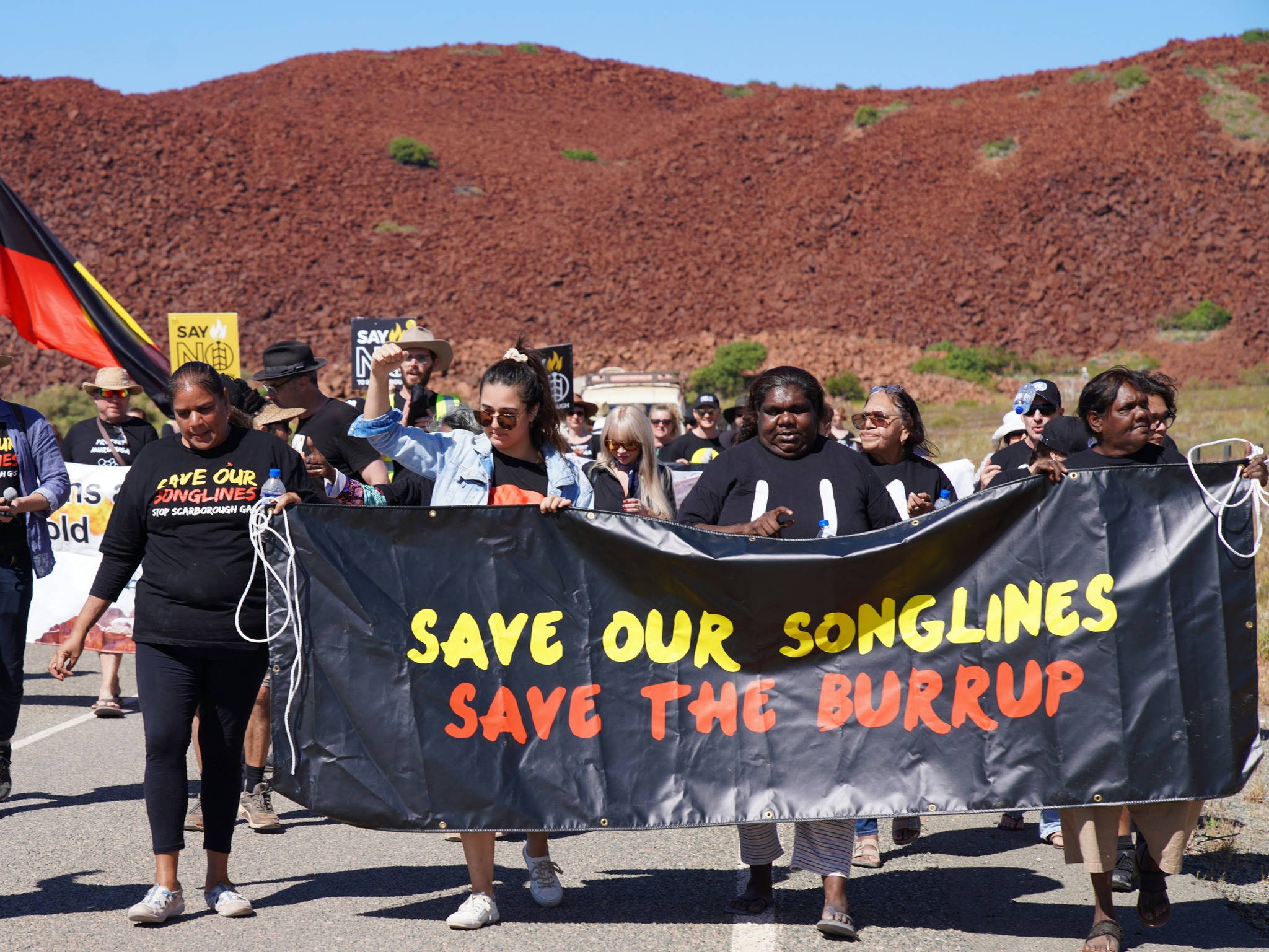 Protestors holding Save our Songlines banner