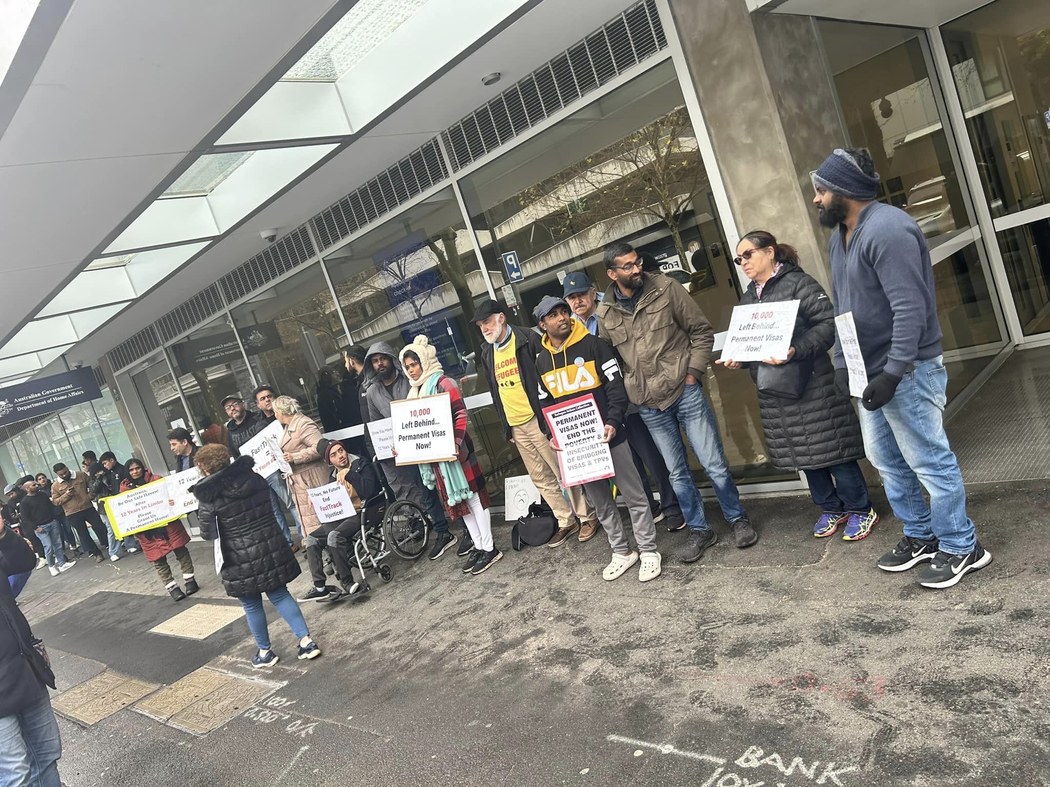 Protesters holding signs outside the Dept of Home Affairs in Docklands, organised by and photo credit from Refugee Women Action for Visa Equality (https://www.facebook.com/RefugeeWAVE/)