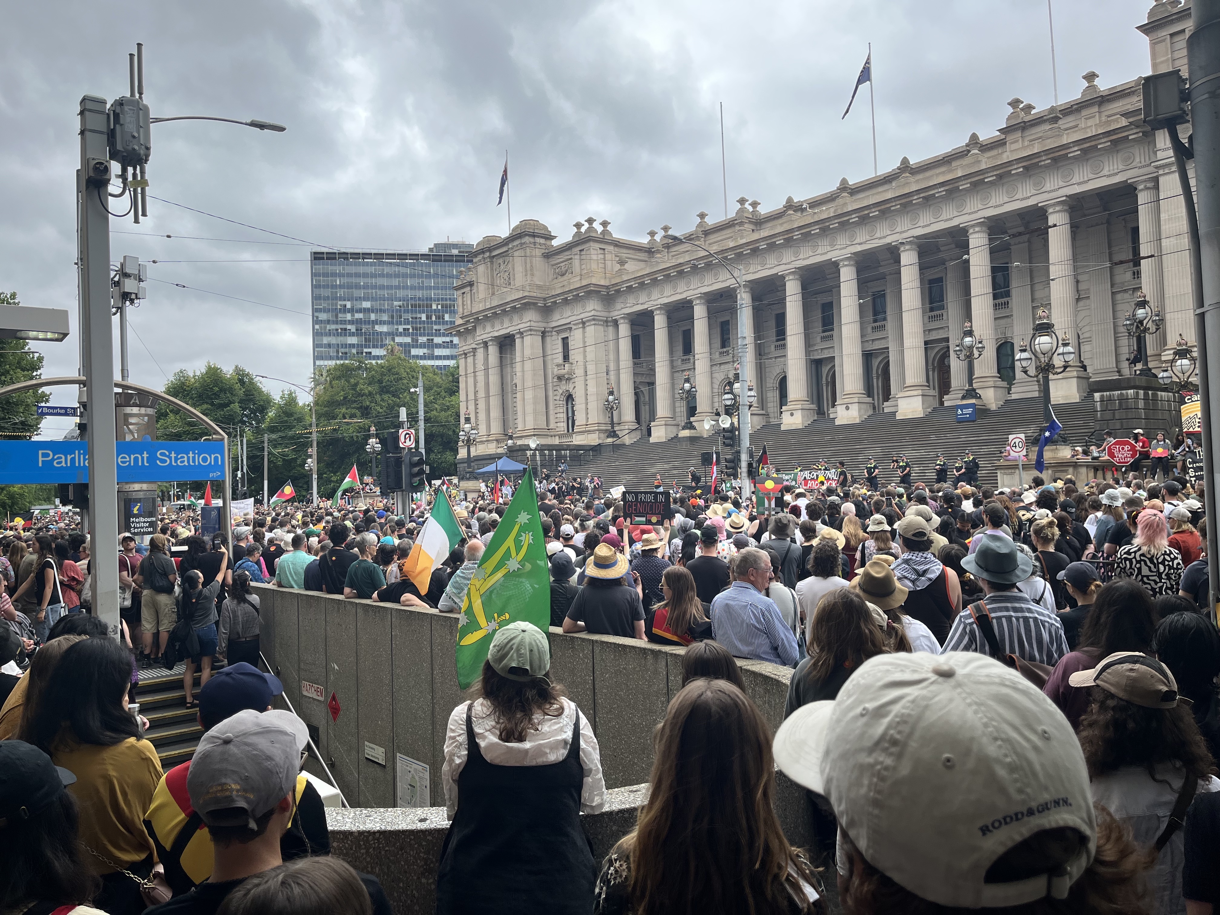 Image of big crowd at invasion day rally and Parliament house in the background