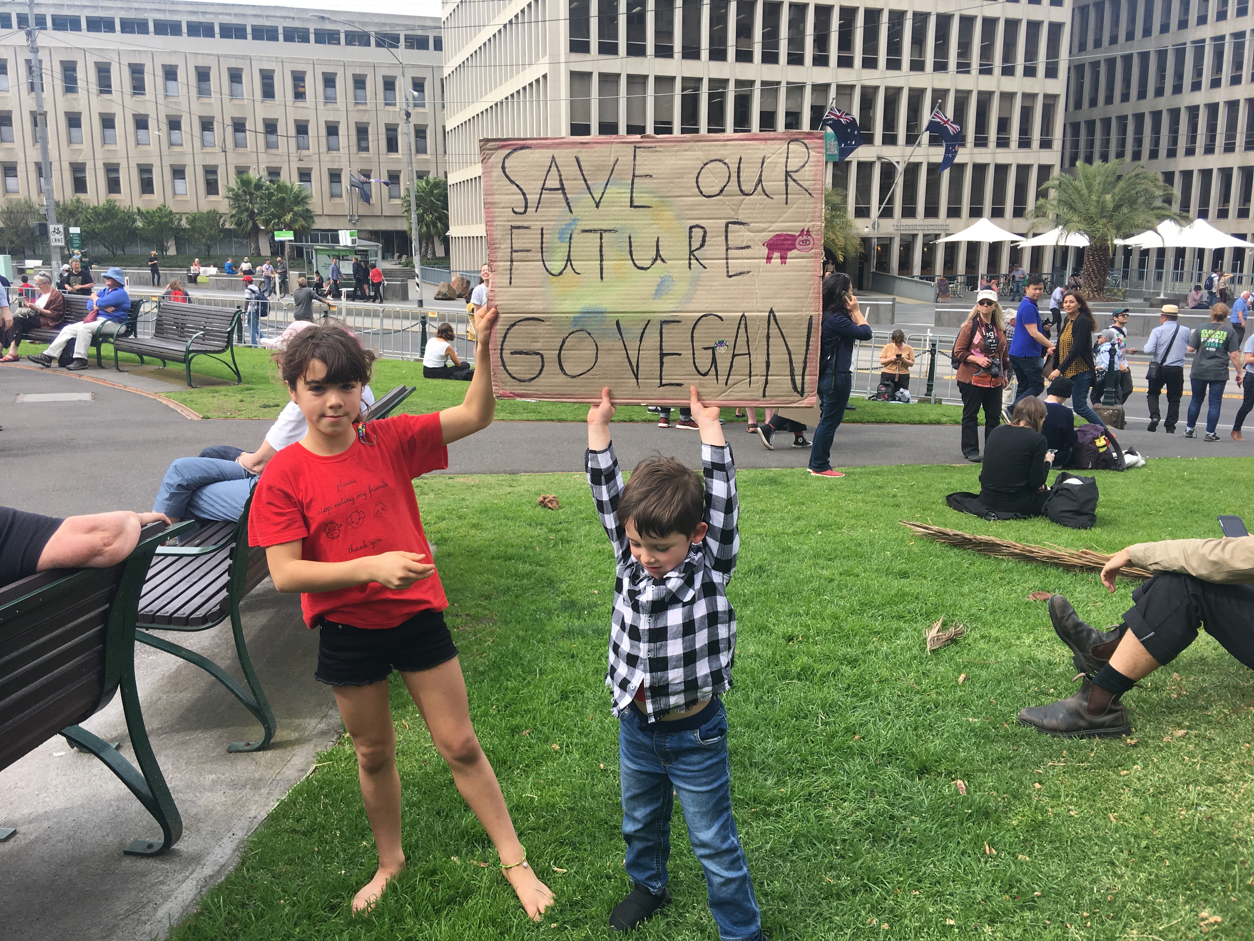 Kids holding up sign that reads, 'Save our Future, Go Vegan'.