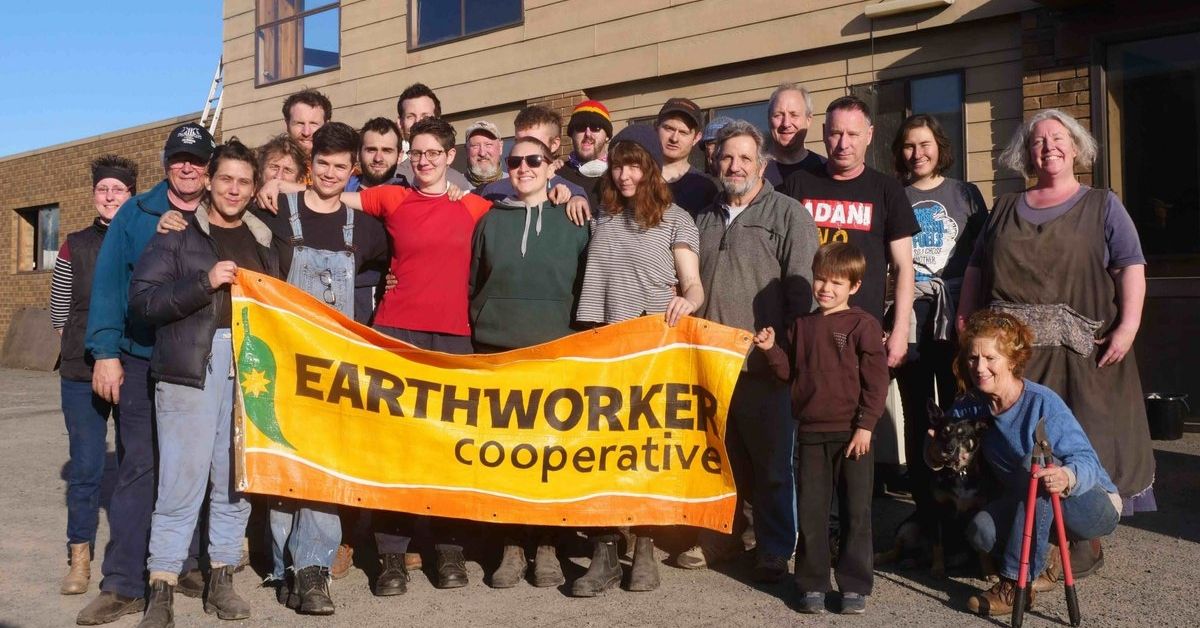 The good folks at Earthworker outside their Morwell factory with an Earthworker banner