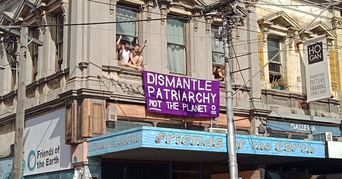 Dismantle patriarchy not the planet - banner hanging from Friends of the Earth's Smith St building