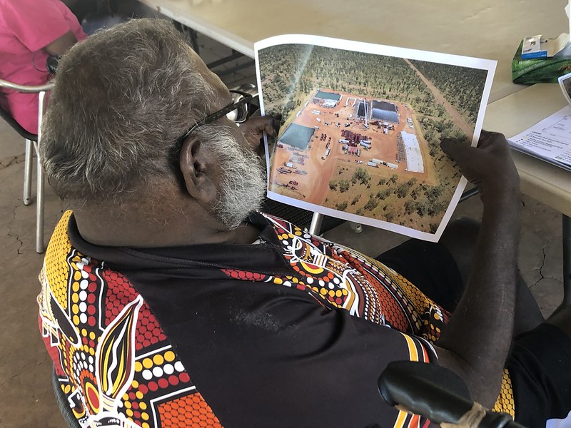 Traditional Owner looks at picture of gas field 