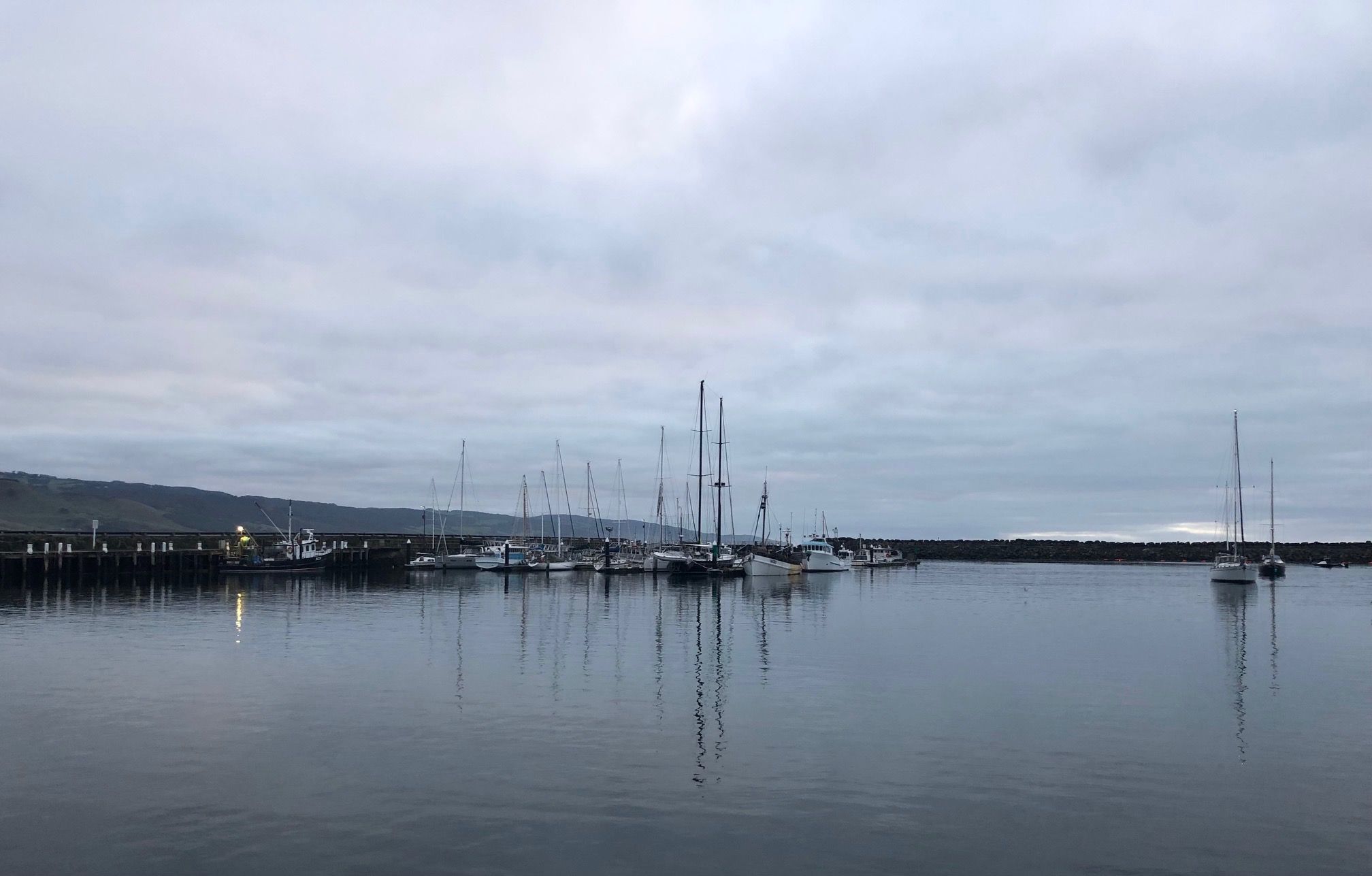 Fishing boats in a bay in the morning: Clouds, sea and water