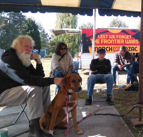 Bruce Pascoe talking to a circle of people in a marquee