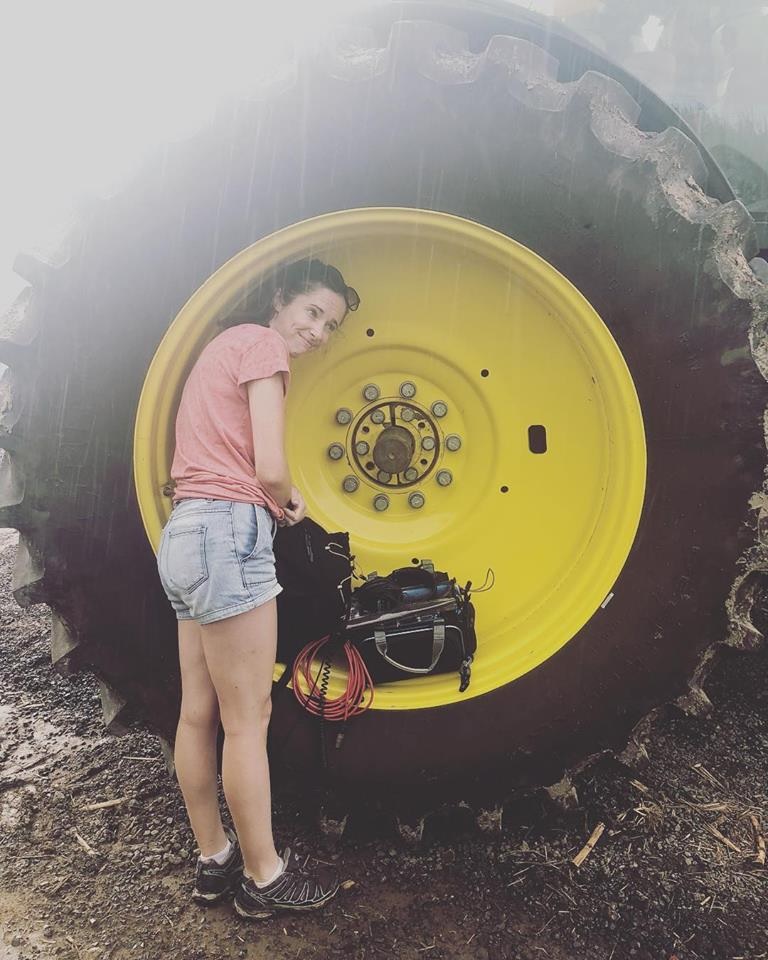 Alicia Butterworth sheltering her sound equipment