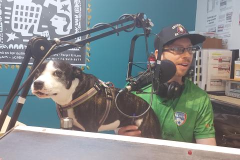 Photo of Nick and his dog Moo Moo in the studio