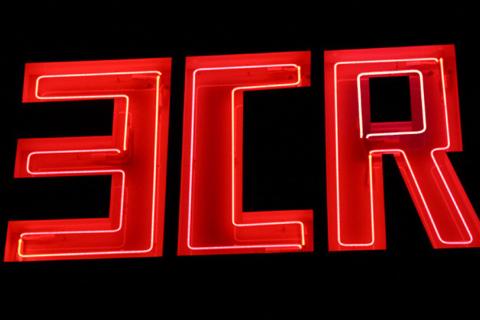 A close-up photograph of an illuminated Neon sign which reads 3CR, taken at night time.