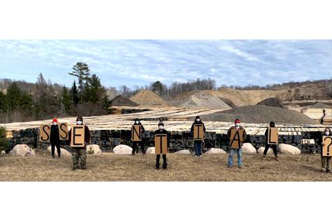 9 protesters/protectors at the Enbridge Line 3 tar sands pipeline construction maintaining physical distancing and holding placards spelling "E.S.S.E.N.T.I.A.L.?"